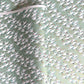 japanese silk-screen handmade paper showing white cranes in flight on a light teal and gold backdrop