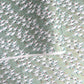 japanese silk-screen handmade paper showing white cranes in flight on a light teal and gold backdrop