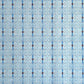 Japanese silkscreen chiyogami paper with a intricate filigree trellis design in blue with red and gold accent