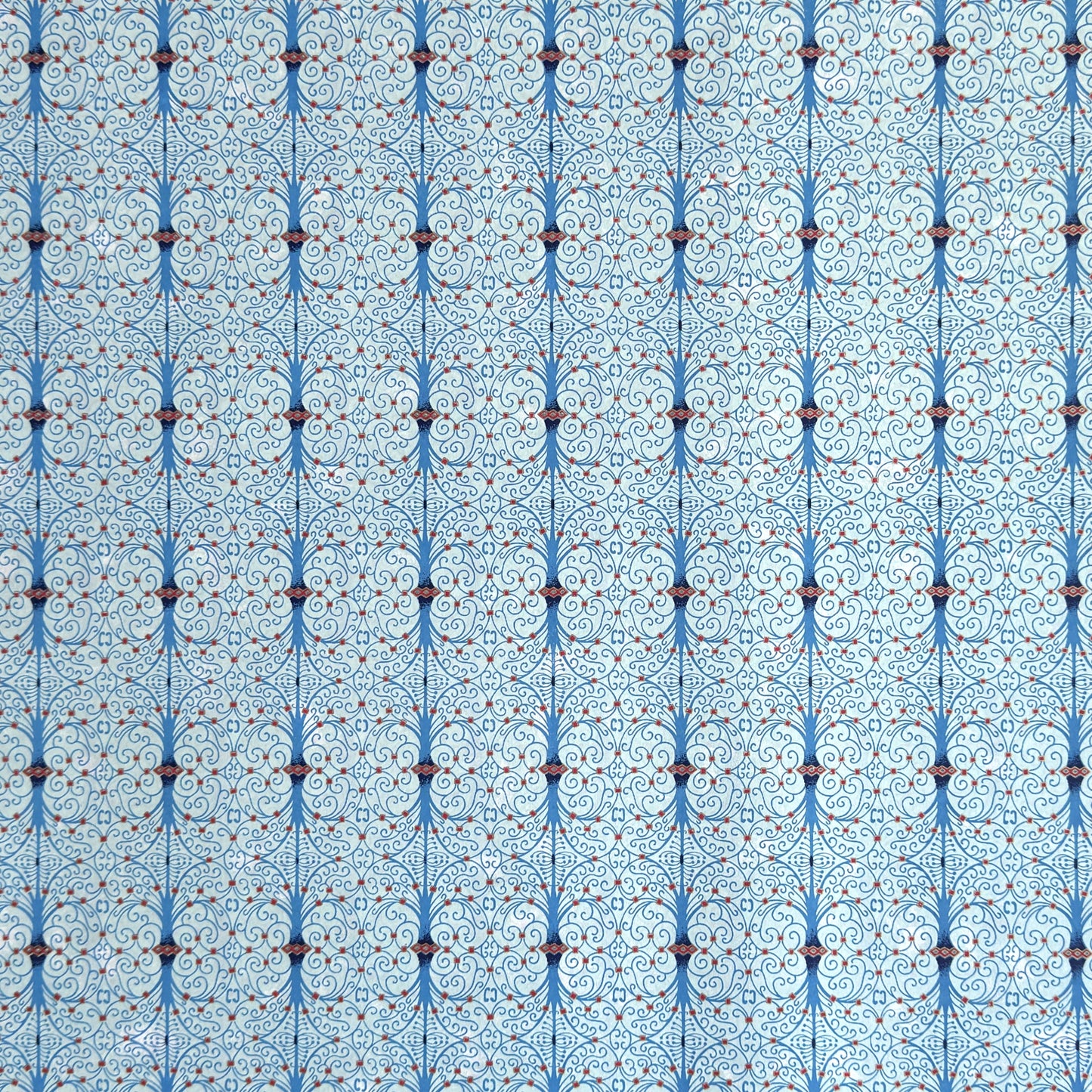 Japanese silkscreen chiyogami paper with a intricate filigree trellis design in blue with red and gold accent