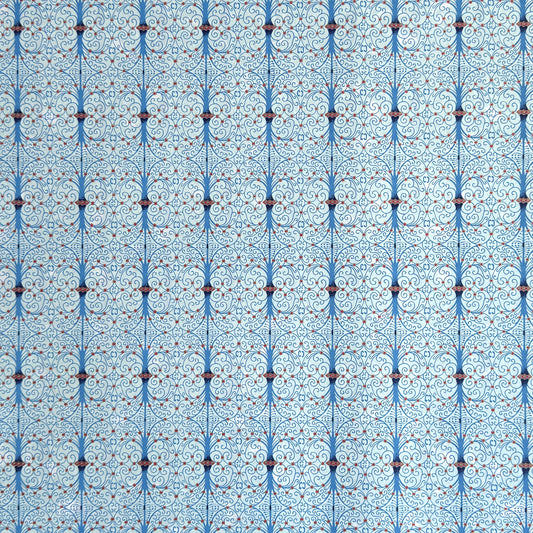 Japanese silkscreen chiyogami paper with a intricate filigree trellis design in blue with red and gold accent