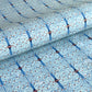 Japanese silkscreen chiyogami paper with a intricate filigree trellis design in blue with red and gold accent