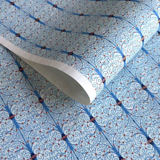 Japanese silkscreen chiyogami paper with a intricate filigree trellis design in blue with red and gold accent