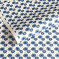 japanese silk-screen handmade paper showing a repeat pattern of blue umbrellas with gold highlights