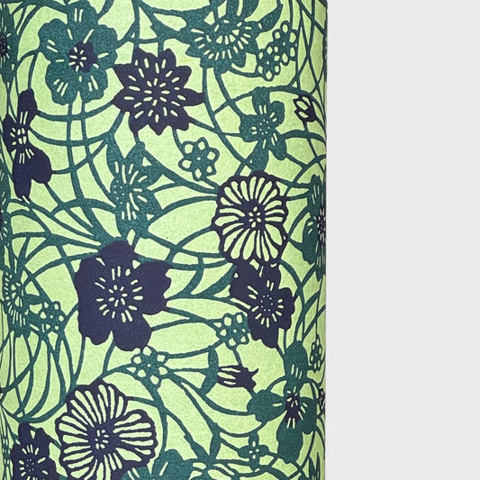 a sheet of katazome paper with a floral design in shades of green and indigo blue. Close up