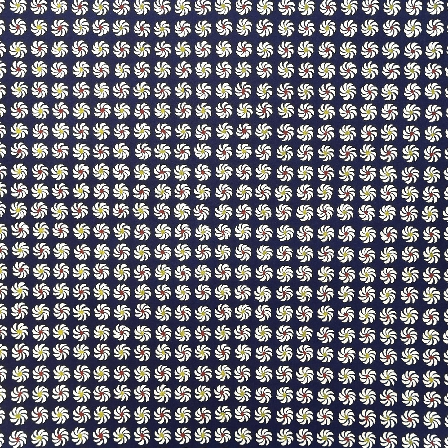 Small pattern with abstract circular flowers in white, red and yellow on a dark blue background. A sheet of katazome paper