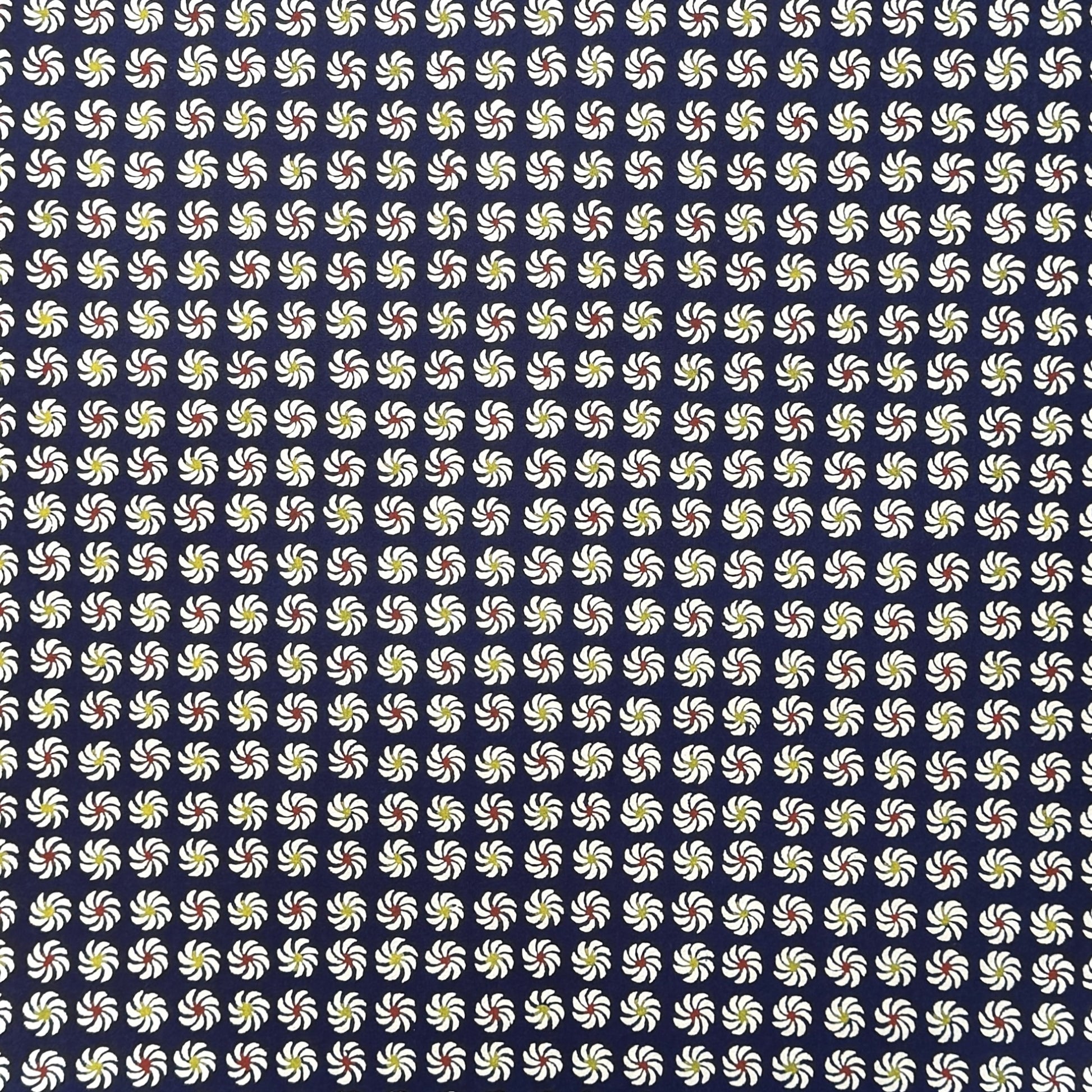 Small pattern with abstract circular flowers in white, red and yellow on a dark blue background. A sheet of katazome paper
