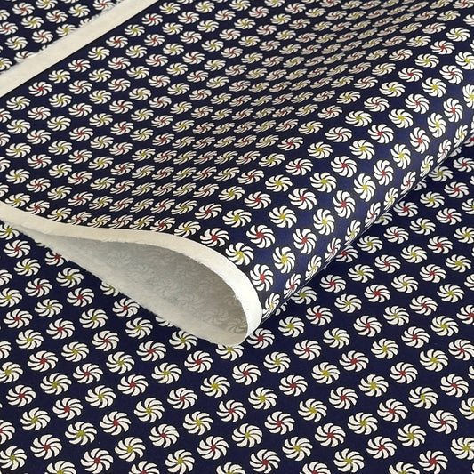 Small pattern with abstract circular flowers in white, red and yellow on a dark blue background. A sheet of katazome paper