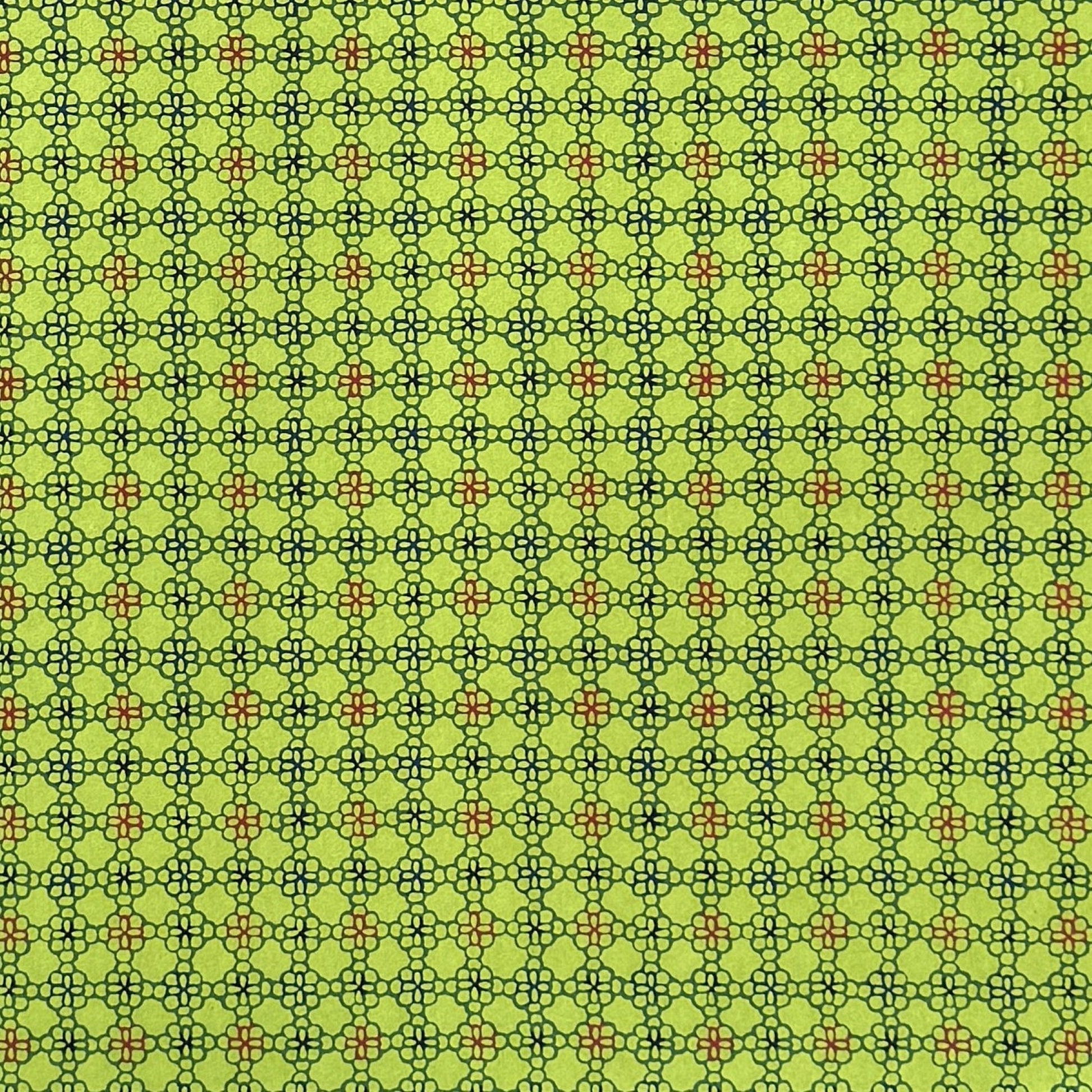 A sheet of Japanese katazome paper with a delicate floral tile repeat pattern on vibrant lime green