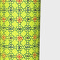 A sheet of Japanese katazome paper with a delicate floral tile repeat pattern on vibrant lime green. Close up