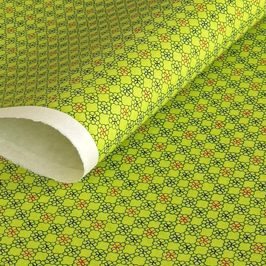 A sheet of Japanese katazome paper with a delicate floral tile repeat pattern on vibrant lime green