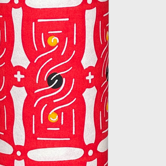 A sheet of katazome paper with a stylised knot design in red on white 