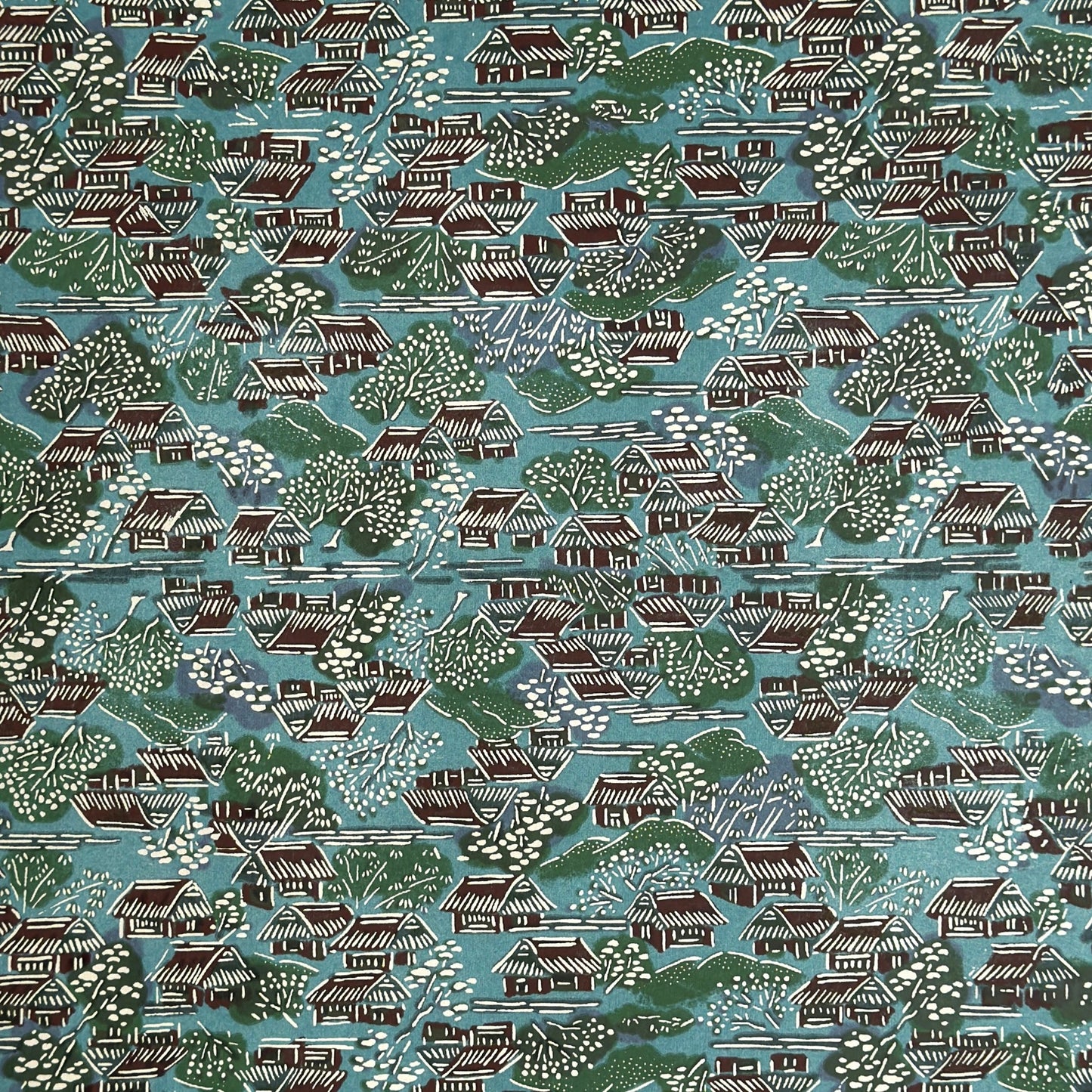 A Japanese pattern of hillside villages.  Katazome stencil-dyed paper from Japan in colours of blue, green, brown and white