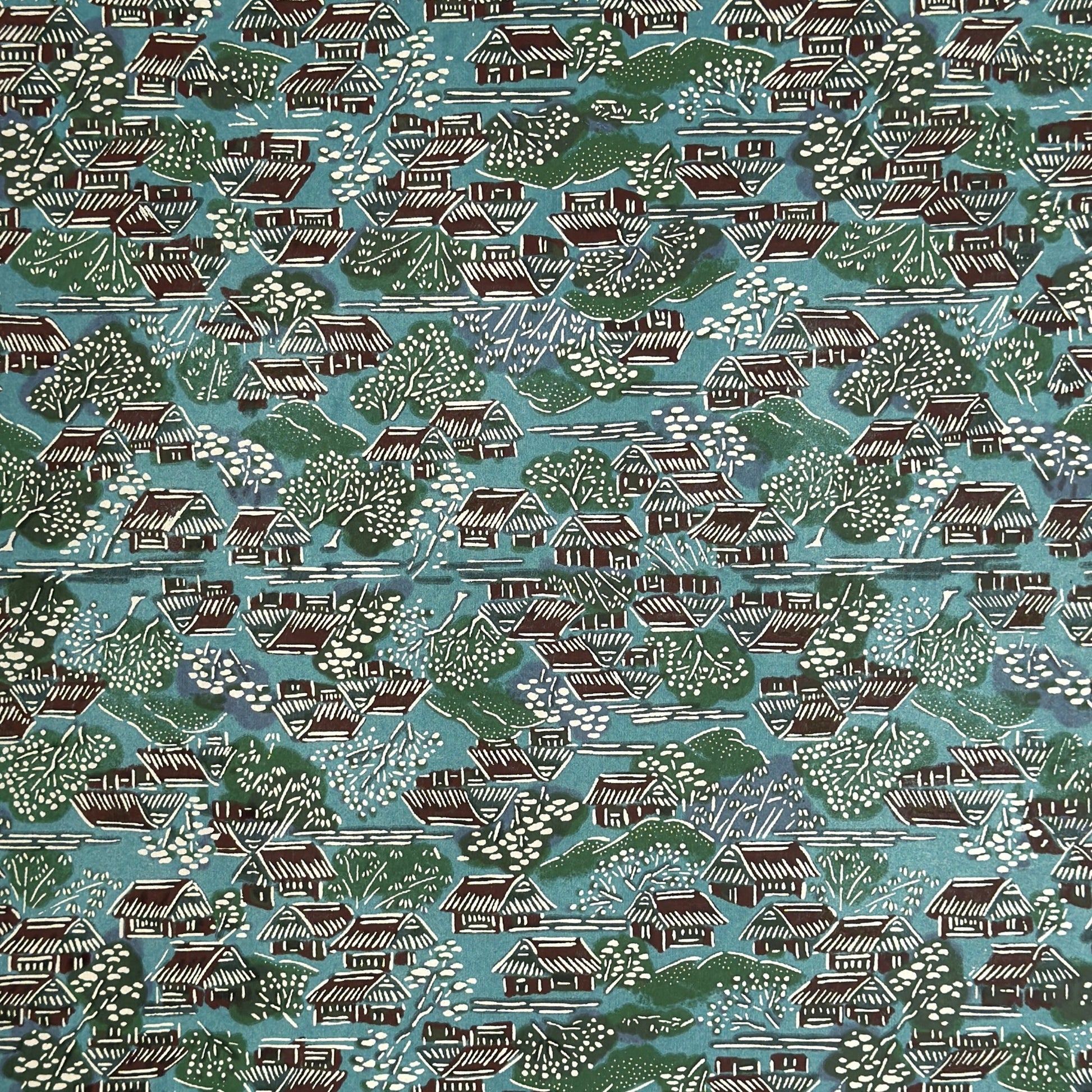 A Japanese pattern of hillside villages.  Katazome stencil-dyed paper from Japan in colours of blue, green, brown and white