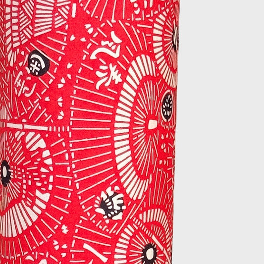 a sheet of Japanese katazome paper with a pattern of red and white umbrellas. Close up 