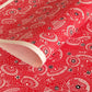 a sheet of Japanese katazome paper with a pattern of red and white umbrellas 