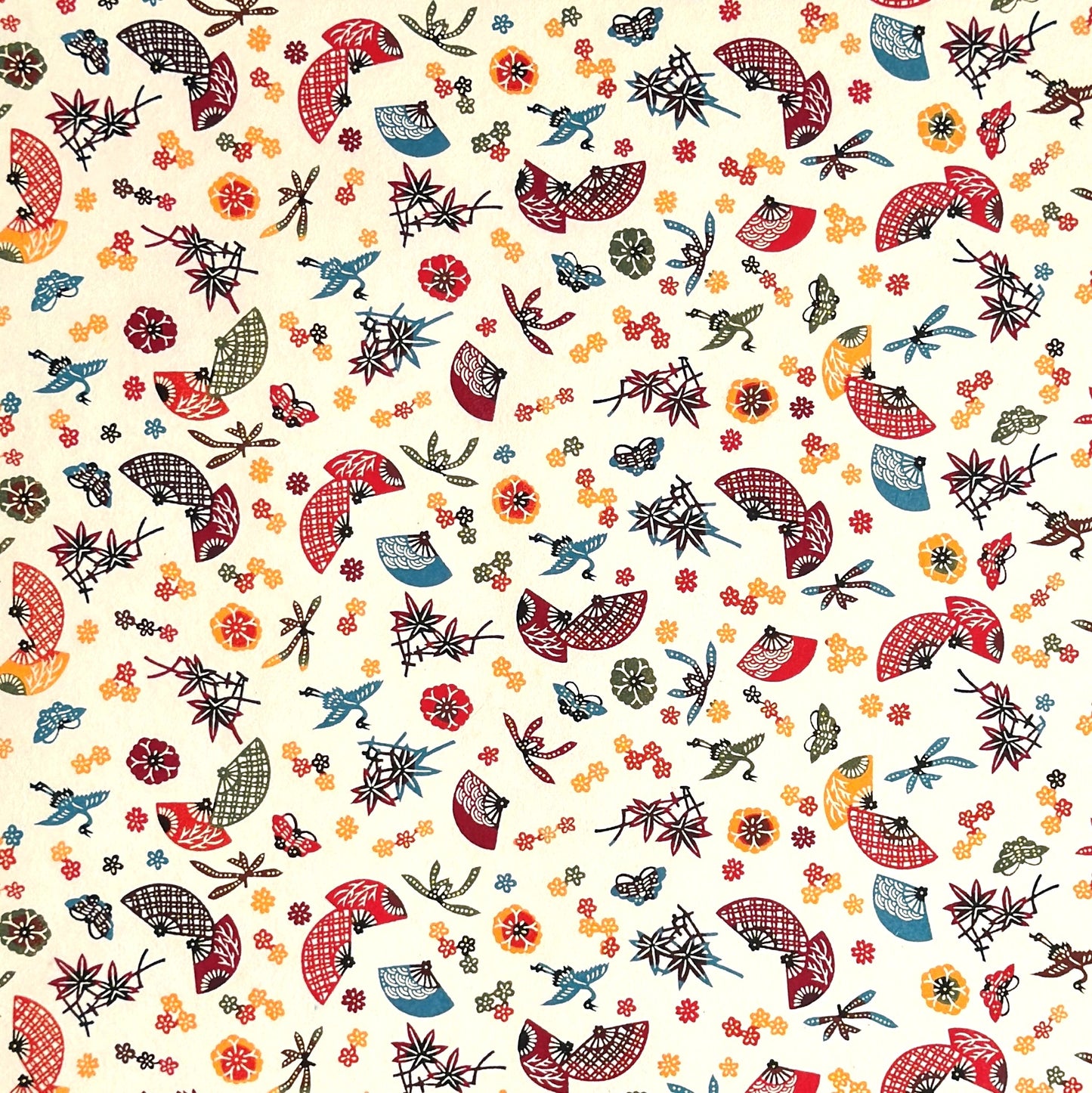 Folding fans (sensu) and cranes (tsuru) amongst flowers and foliage.  A multicoloured pattern on Japanese katazome paper