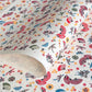 Folding fans (sensu) and cranes (tsuru) amongst flowers and foliage.  A multicoloured pattern on Japanese katazome paper