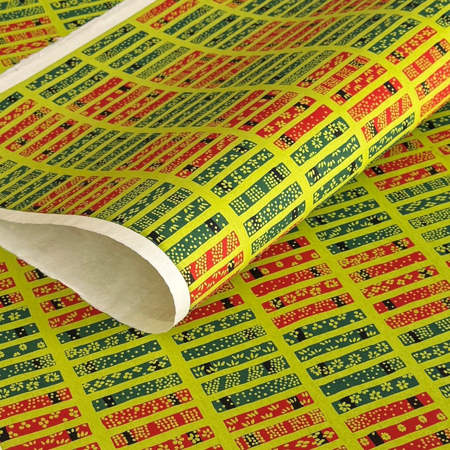 Floral patterned rectangles on vibrant lime green. A sheet of katazome paper