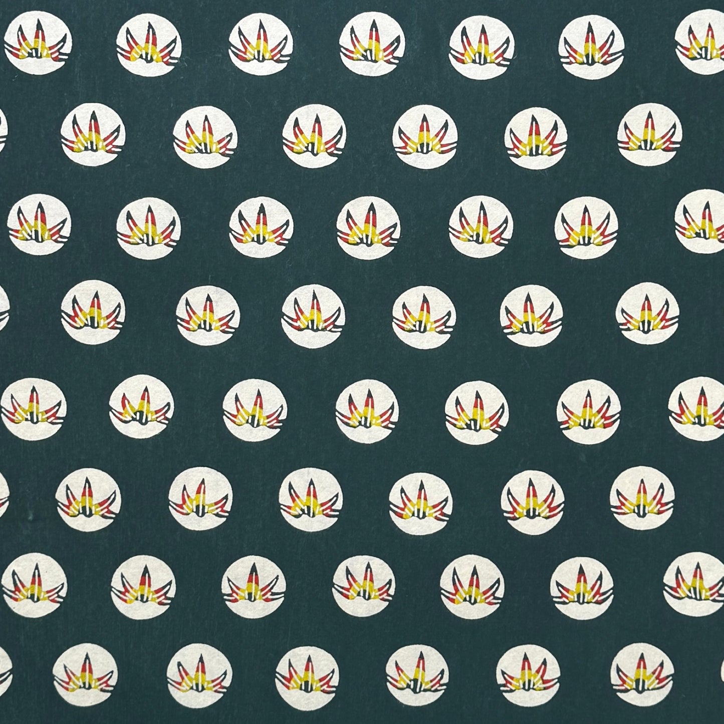 Traditional pattern a Japanese circular crest of a colourful lotus flower on a dark teal.  A shhet of katazome paper