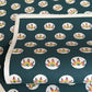 Traditional pattern a Japanese circular crest of a colourful lotus flower on a dark teal.  A sheet of katazome paper