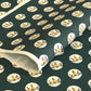 Traditional pattern a Japanese circular crest of a colourful lotus flower on a dark teal.  A sheet of katazome paper