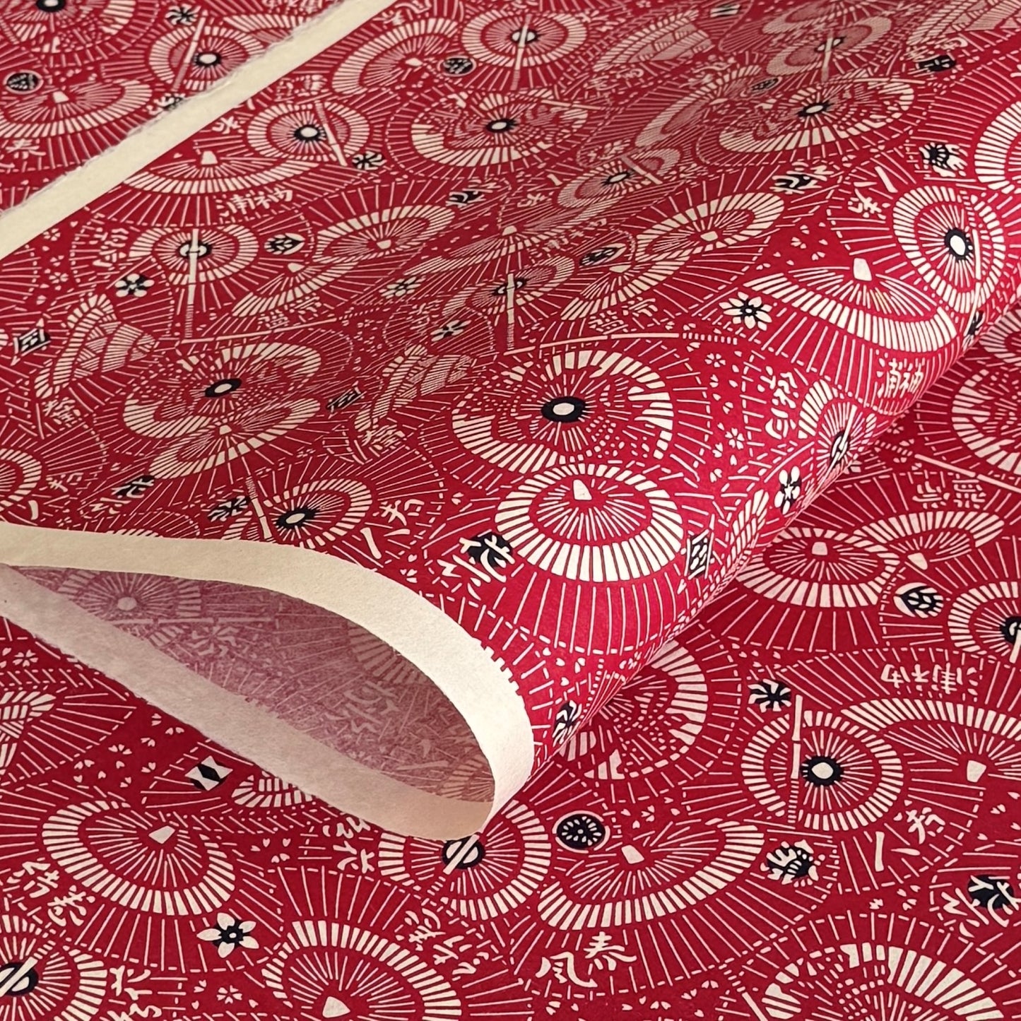 A repeat pattern of Japanese umbrellas (wagasa) in rich berry pink and white. A shhet of katazome paper