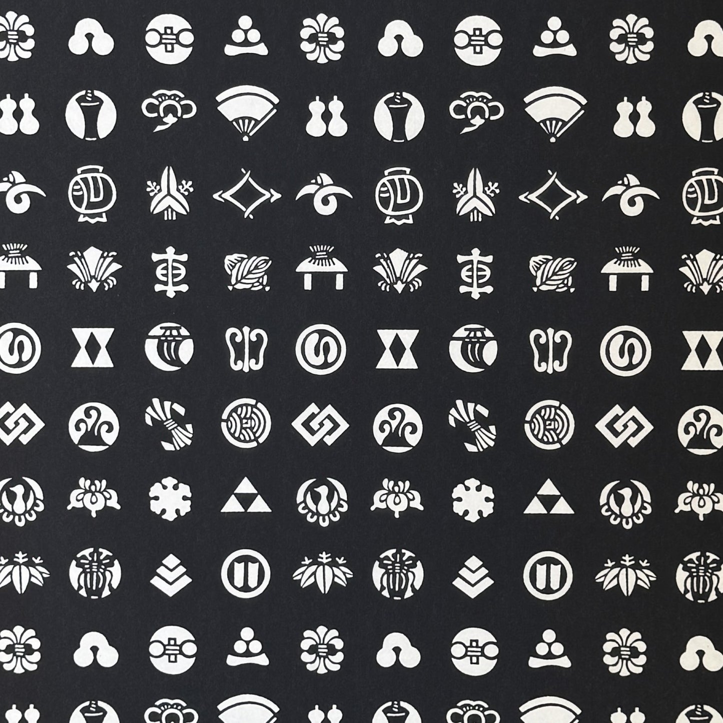 Japanese crests (mon) in monochrome. A sheet of stencil-dyed katazome paper in black with white crest symbols