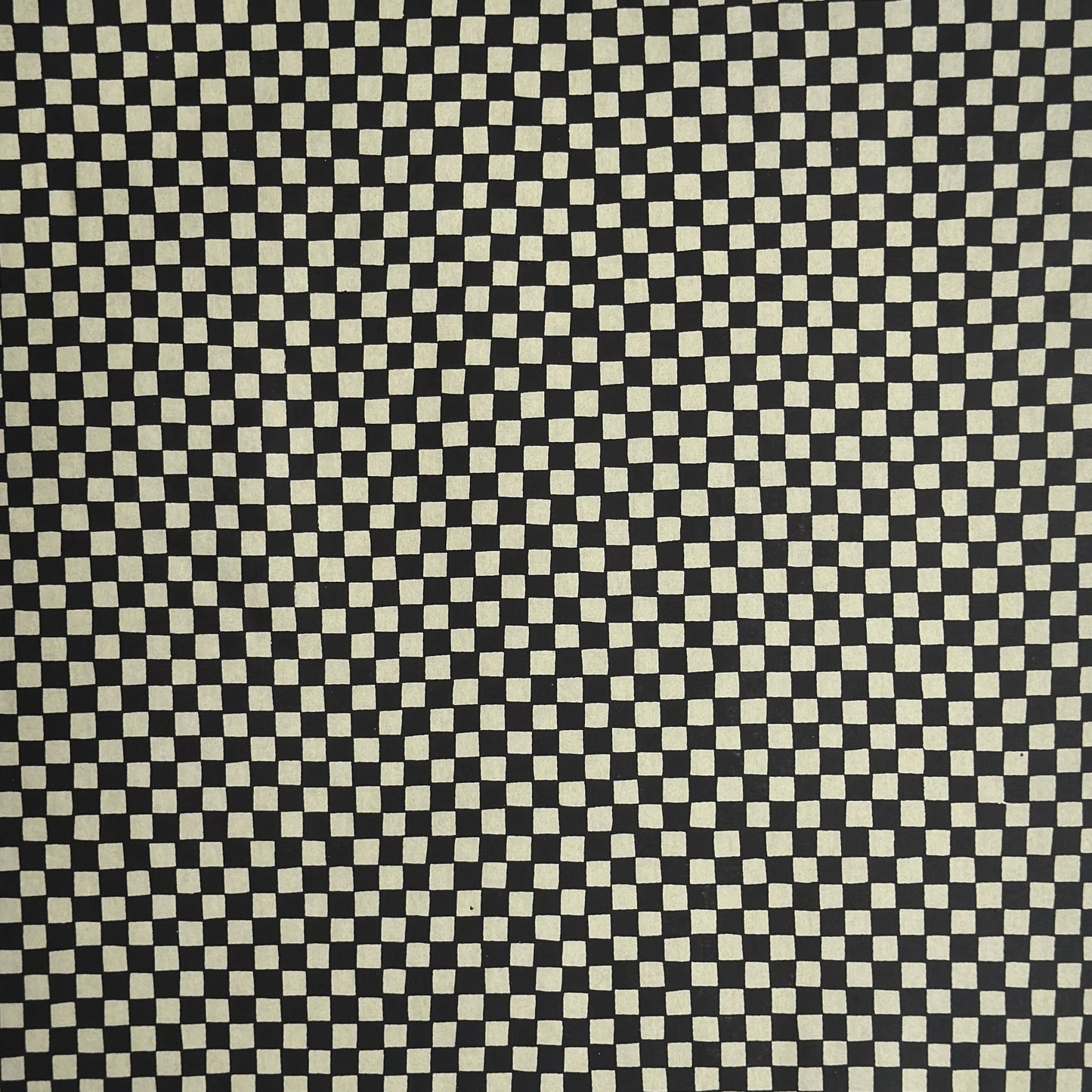 a sheet of Japanese katazome paper with a chequer pattern (ichimatsu) in black and soft grey