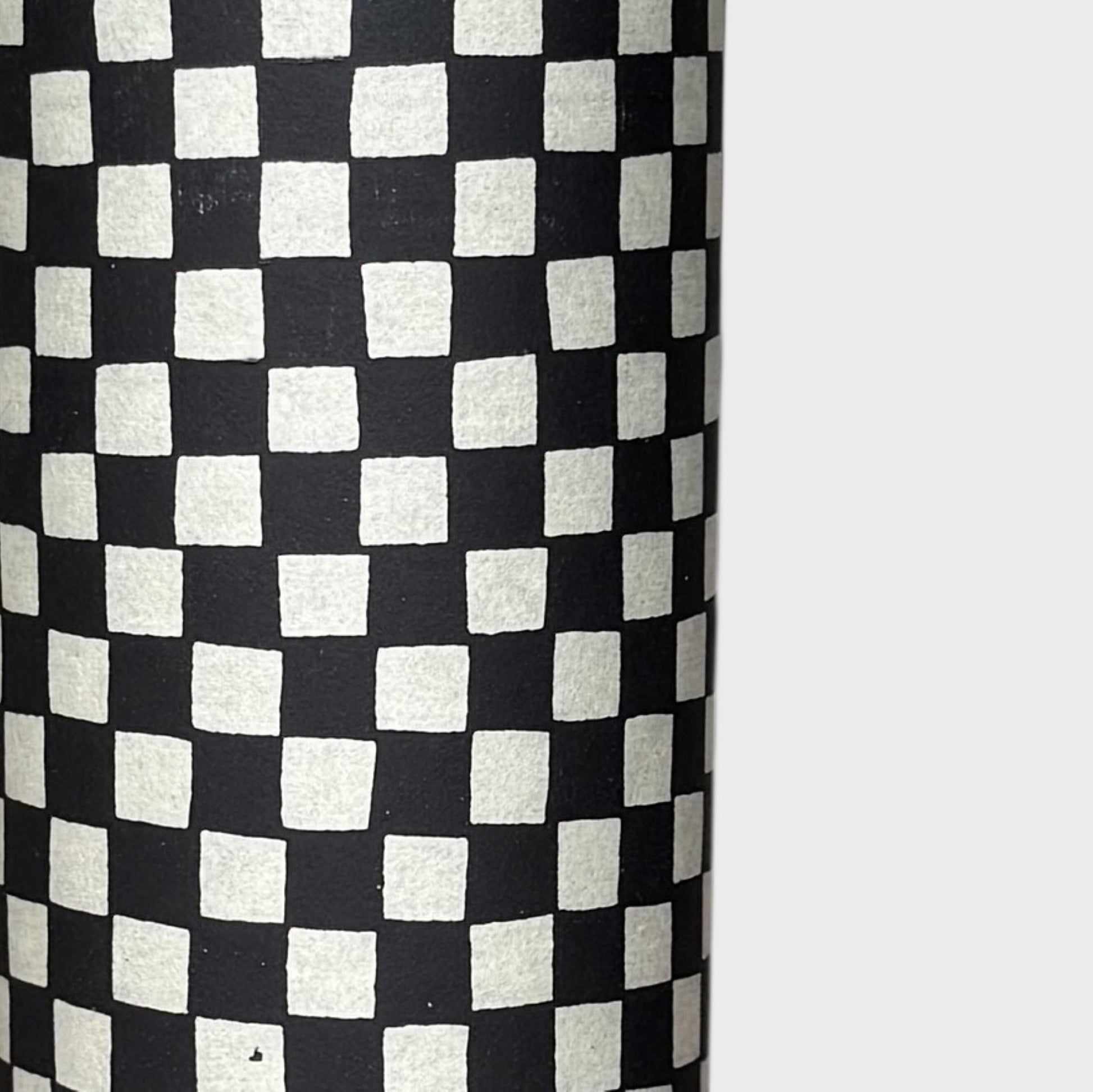 a sheet of Japanese katazome paper with a chequer pattern (ichimatsu) in black and soft grey. Close up