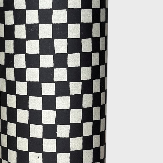 a sheet of Japanese katazome paper with a chequer pattern (ichimatsu) in black and soft grey. Close up