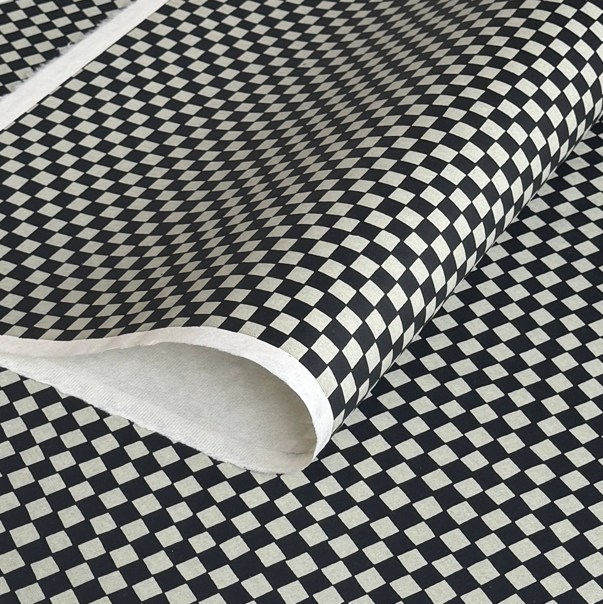 a sheet of Japanese katazome paper with a chequer pattern (ichimatsu) in black and soft grey