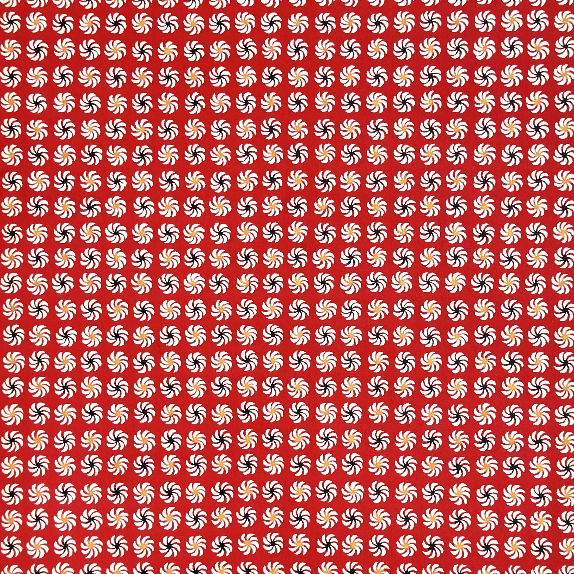 a sheet of Japanese katazome-shi paper with a repeat pattern of circular abstract flowers in white