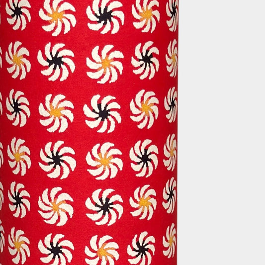 a sheet of Japanese katazome-shi paper with a repeat pattern of circular abstract flowers in white. Close up