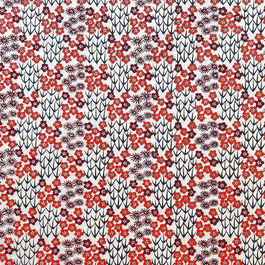 Japanese katazome-shi paper stencil -dyed with a small red flower design, little black stems on ivory paper.