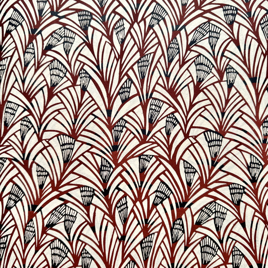 Japanese katazome-shi stencil-dyed paper with a fan-like pattern in deep maroon and black on cream paper.