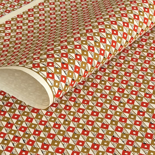 Geometric two-tone brown diamond (kuginuki tsunagi) repeat pattern on a sheet of Japanese katazome paper