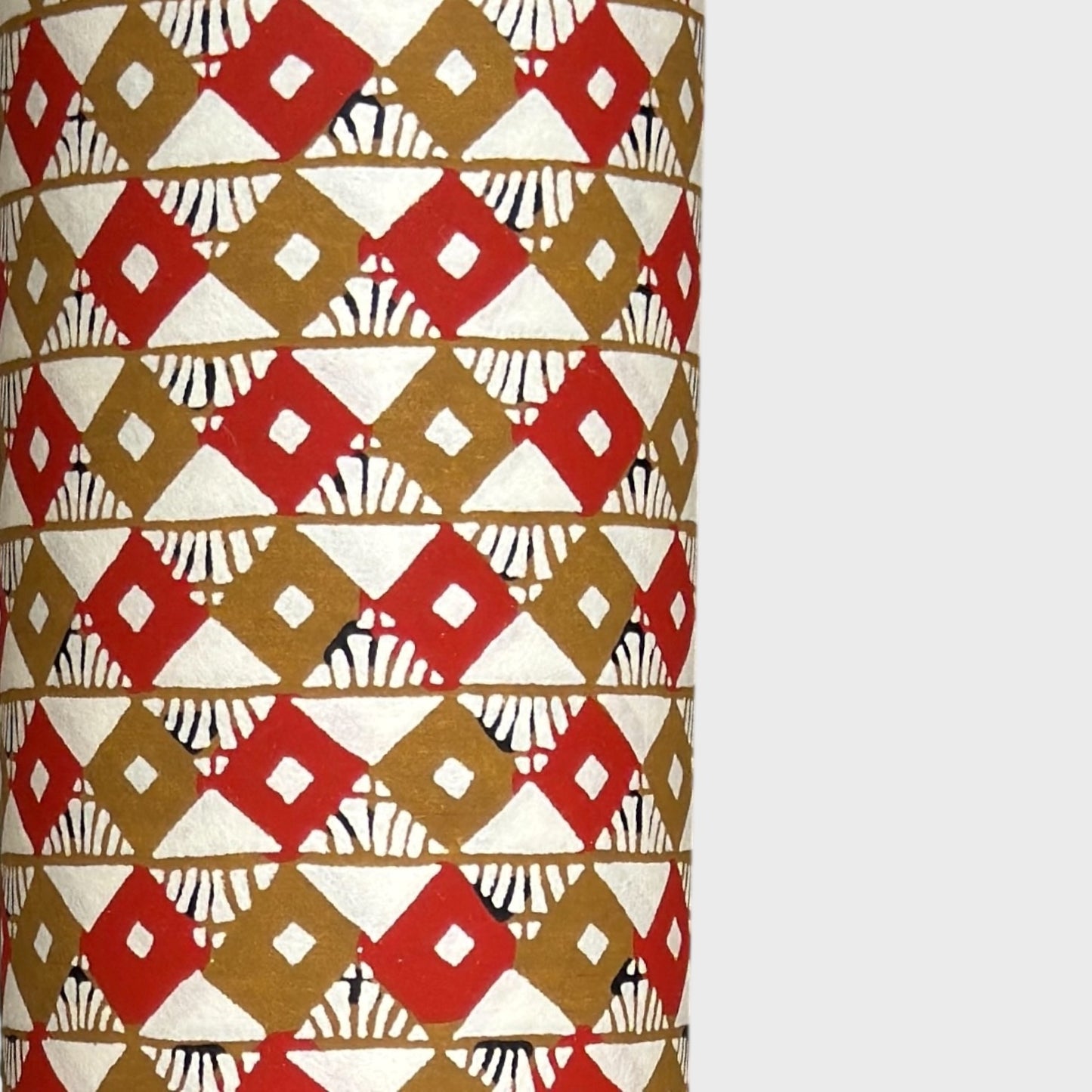 Geometric two-tone brown diamond (kuginuki tsunagi) repeat pattern on a sheet of Japanese katazome paper. Close up