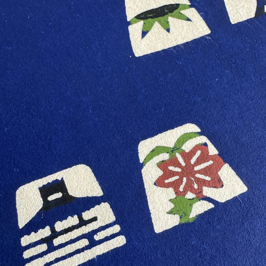 Japanese katazome-shi paper in blue with small Japanese Mon motifs. Close-up