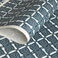 Japanese katazome stencil dyed paper with a repeat pattern of muted blue knots.