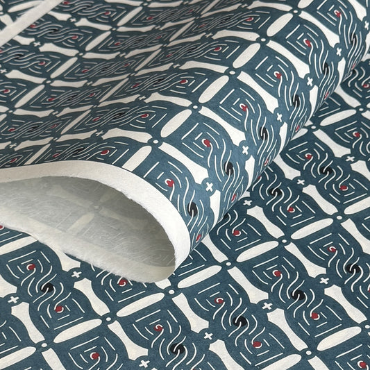 Japanese katazome stencil dyed paper with a repeat pattern of muted blue knots.
