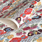 japanese stencil-dyed handmade paper with traditional botanical pattern in red, brown, yellow and blue