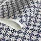 Japanese katazome-shi paper in navy blue and cream chequerboard pattern with motifs of autumn - acorns and wheat.