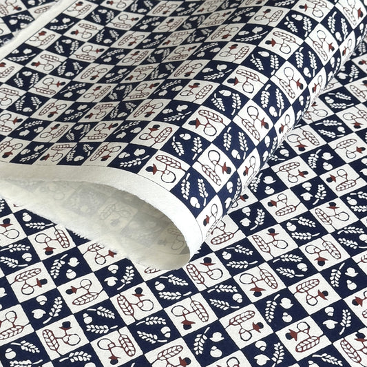 Japanese katazome-shi paper in navy blue and cream chequerboard pattern with motifs of autumn - acorns and wheat.