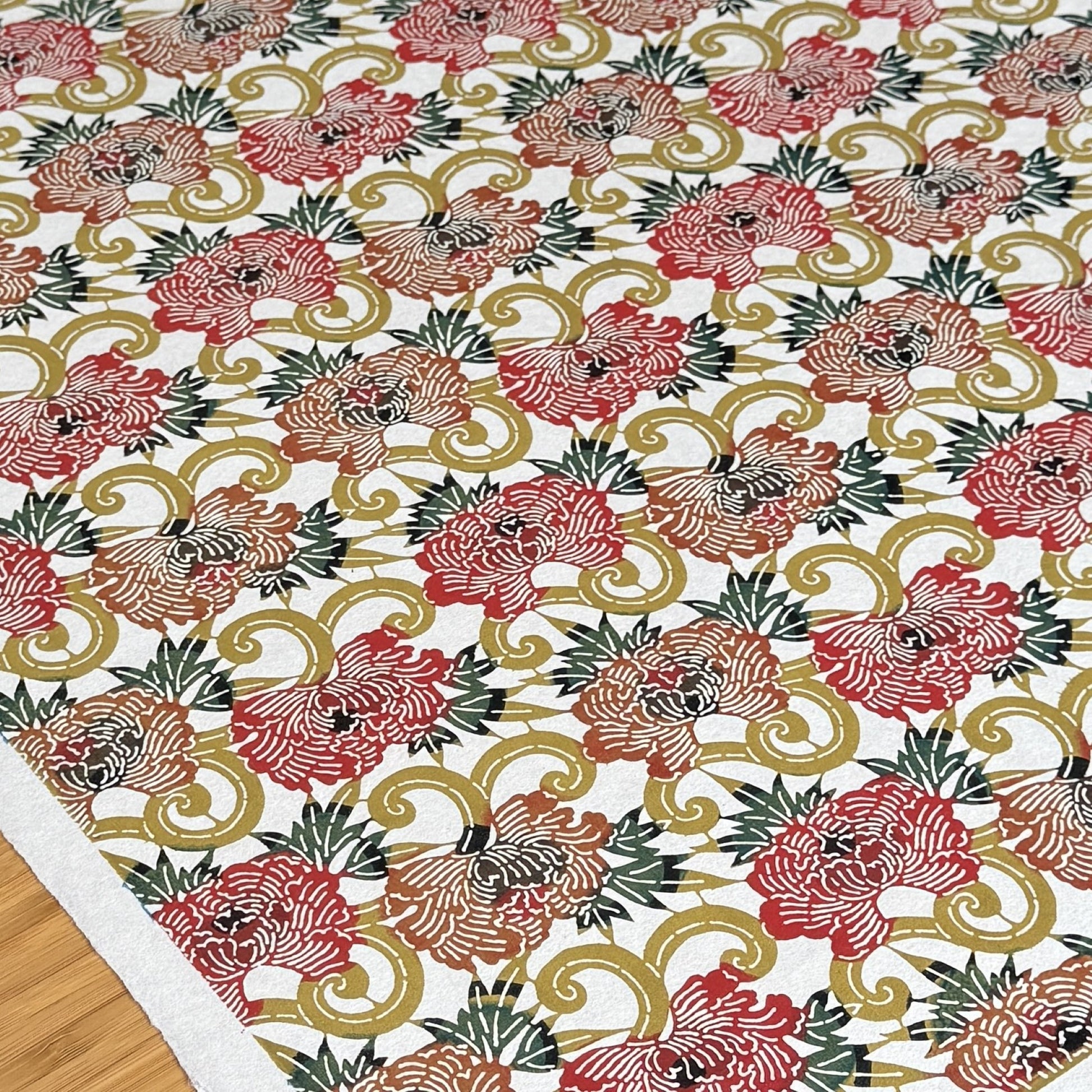 Japanese Katazome-shi stencil-dyed paper with repeat pattern on stylised peonies in autumnal colours.