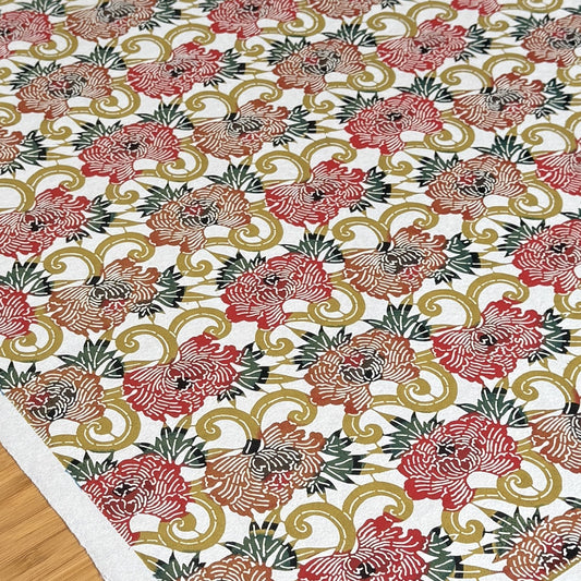 Japanese Katazome-shi stencil-dyed paper with repeat pattern on stylised peonies in autumnal colours.