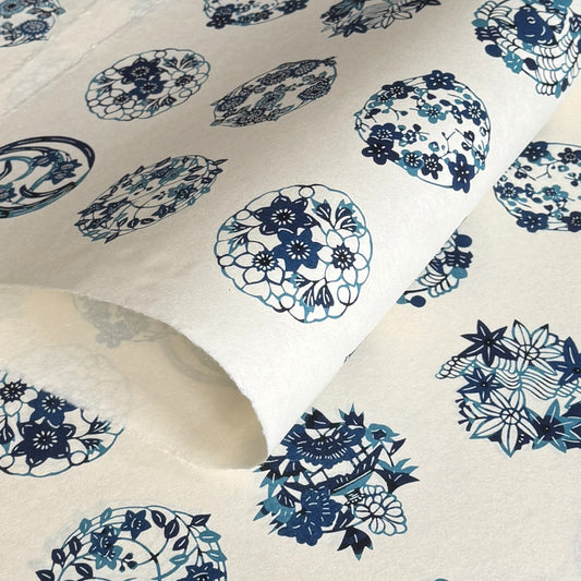 japanese stencil-dyed handmade paper with traditional blue botanical circles pattern on ivory backdrop