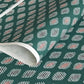 japanese stencil-dyed paper with geometric oval pattern in white, black and red on green background