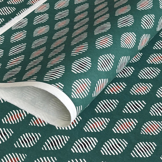 japanese stencil-dyed paper with geometric oval pattern in white, black and red on green background