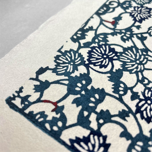 japanese stencil-dyed handmade paper with small scale floral repeat in dark teal and blue